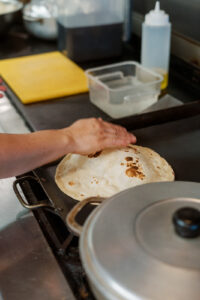 Eda makes the tortillas by scratch to order