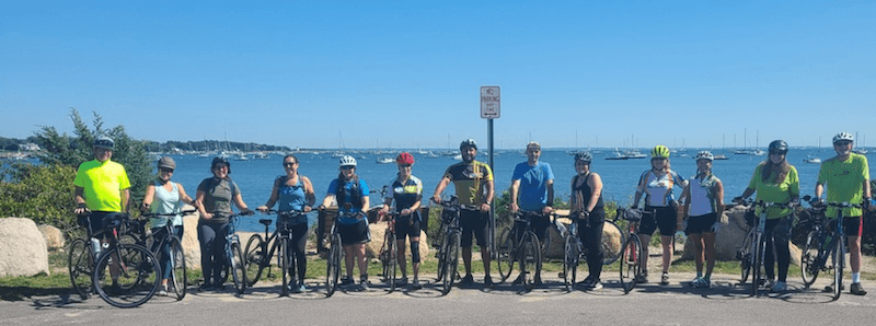 A group of bicylists in front of the Bay