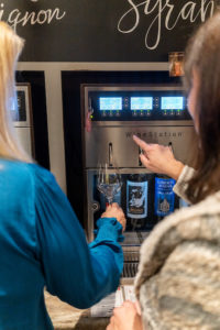 Friends at the wine dispensing stations