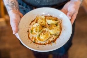 Chef Mike Rose holding a bowl of his lobster tortellini appetizer