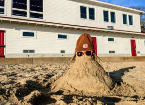 A sandman with hat and sunglasses on Onset Beach