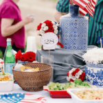 A table set with food and flags, people in background