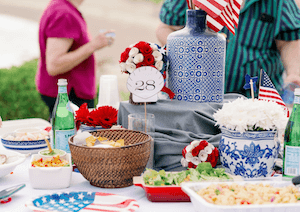 A table set with food and flags, people in background