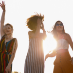 3 women dancing in the sun