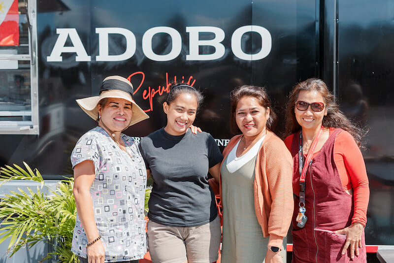Merose in front of the Adobo Republic truck with customers
