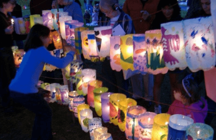 A child standing in front of a row of lanterns