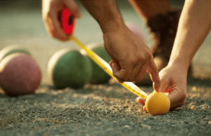 Person measuring for a bocce game