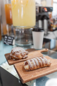 Pistachio scone and strawberry cheesecake danish on the counter