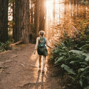 A woman walking through the forest