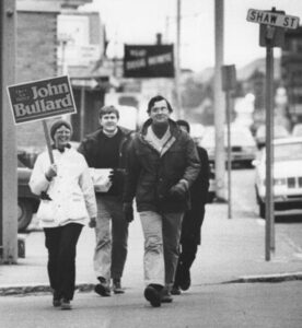 John Bullard walking down the street with supporters