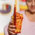 Jackie holding the mangonada at La Fruta Loca