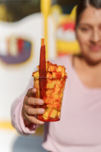 Jackie holding the mangonada at La Fruta Loca