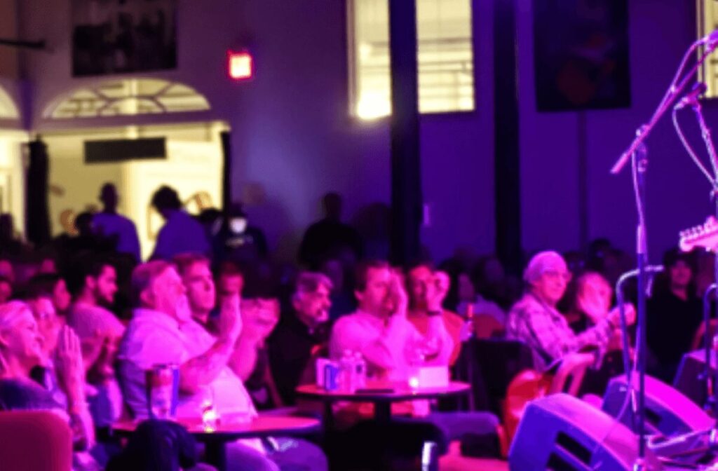 An audience listening to music