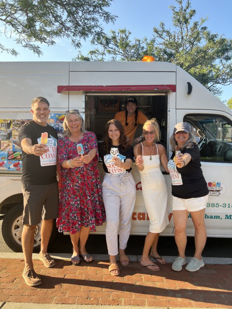 People enjoying ice cream outside of an ice cream truck