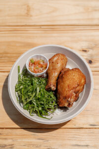 A plate with chicken and greens