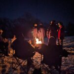 People gathering around a campfire