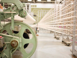 A 12-foot dobby loom with cotton creel pictured from the side