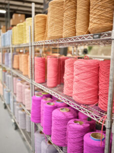 Shelves with yarn colors Luna, Venus, and Barragan