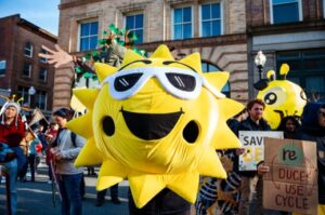 An Aha! parade participant dressed up as the sun!