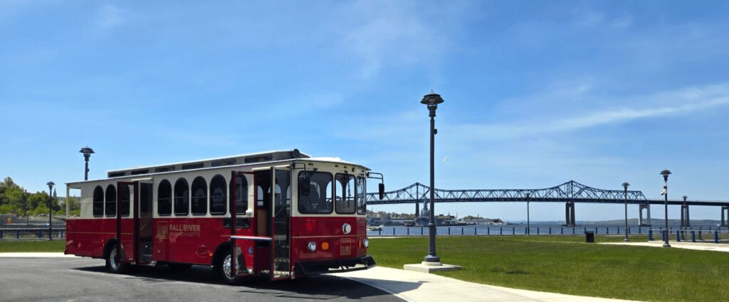 A red trolley with Braga Bridge in background