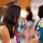 WIne being poured into a festival attendee's glass