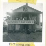 An old black and white snapshot of women holding a Westport Art Group banner