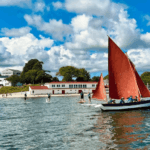 The Dascombe Gig sailing in front of the Onset Bay Center