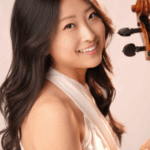 Cellist Sydney Lee, holding her cello