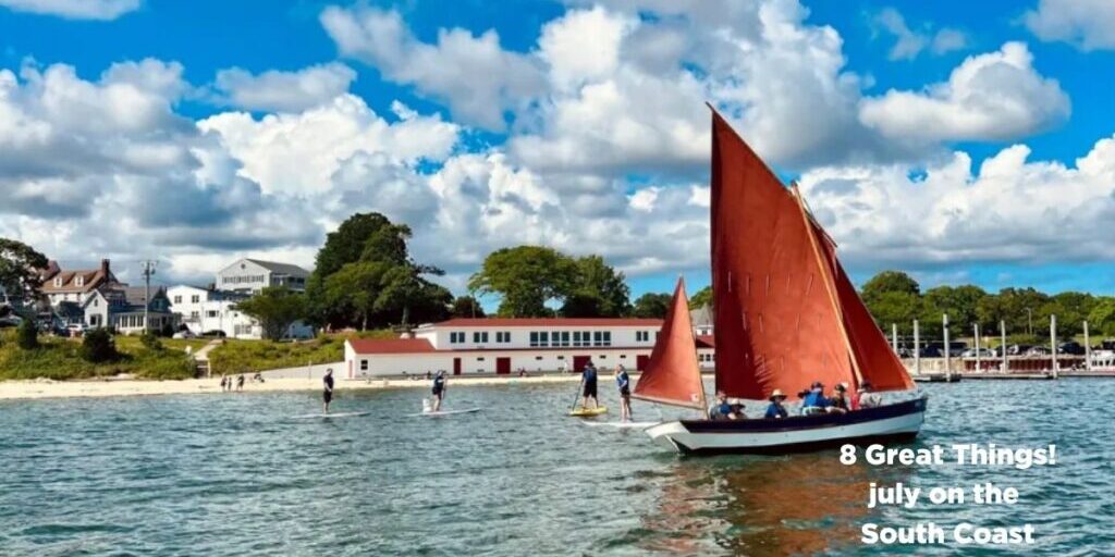 Sailboat with red sail in front of the Onset Bay Center