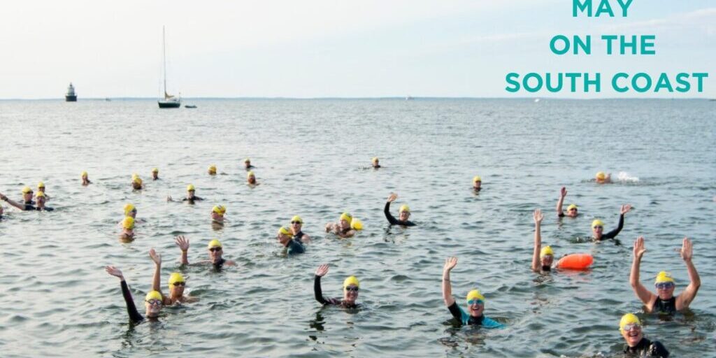 Swimmers, waving from the water