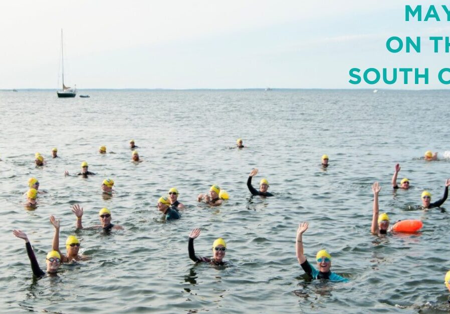 Swimmers, waving from the water