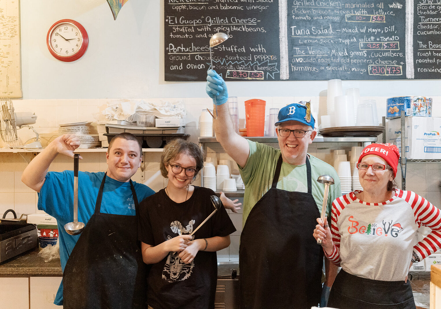 Staff at destination soup, smiling behind the counter