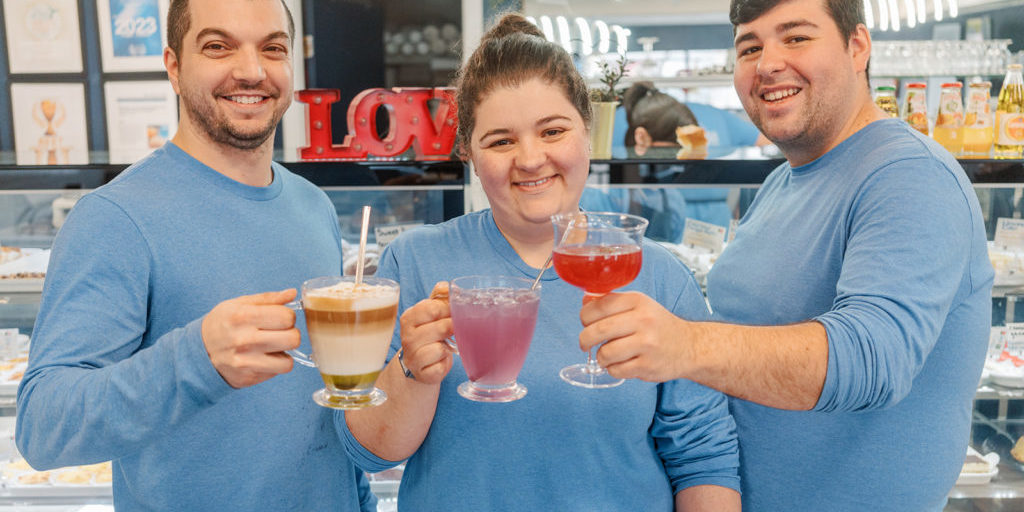 Kevin, Erica and Andrew, owners of Europa Pastries, holding festive drinks