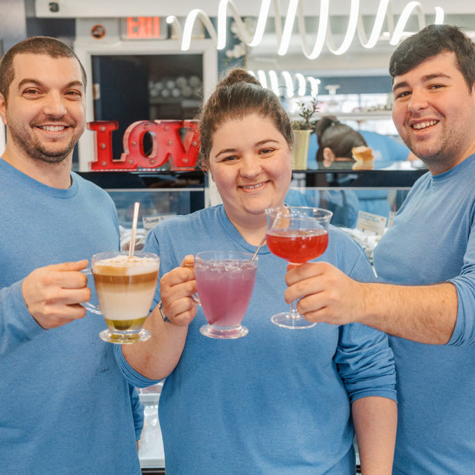 Kevin, Erica and Andrew, owners of Europa Pastries, holding festive drinks