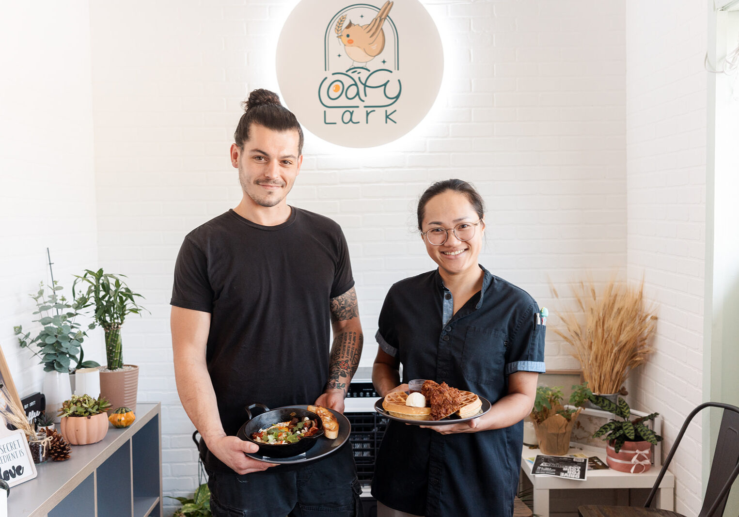 Tyson and Faye, owners of Loafy Lark, holding favorite breakfast specials