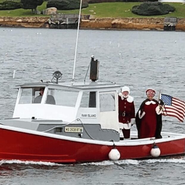 Mr. and Mrs. Claus on a motor boat