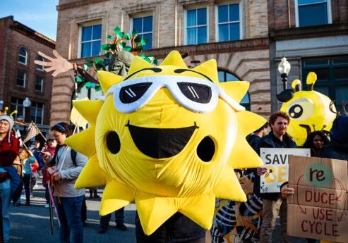 An Aha! parade participant dressed up as the sun!