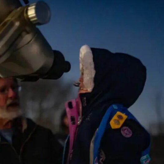 Someone gazing at the stars through a telescope